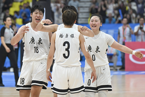 ◎ 十一月十五日,在佛山順德德勝體育中心舉行的第十五屆全國運動會籃球項目女子成年組決賽中,廣東隊七十四比六十八戰勝四川隊,時隔八年再奪金牌。圖為廣東隊獲勝後,隊友擁抱楊力維(中)。(中新社記者 陳驥旻 攝)